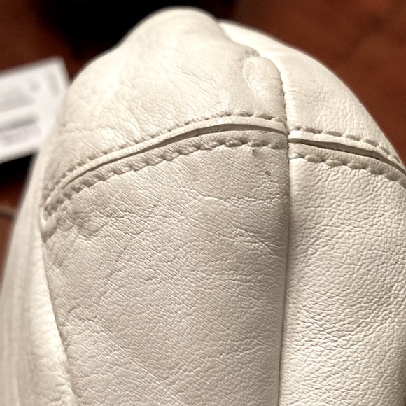 COACH PURSE. Bone colored with tan trim. Pleated. Back slip pocket. Clean inside - Picture 6 of 10